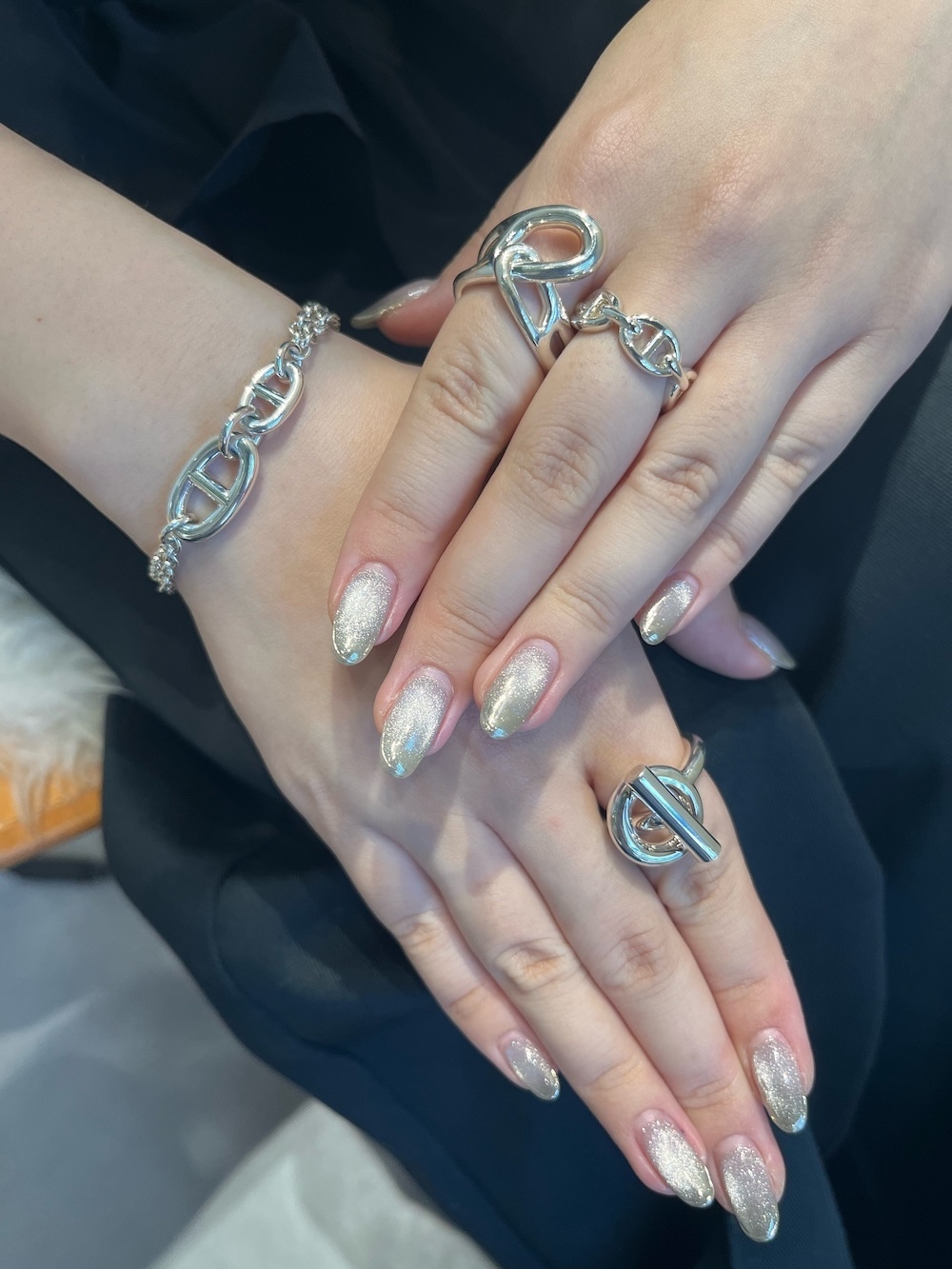 両手で指輪の重ね付けを楽しむ人